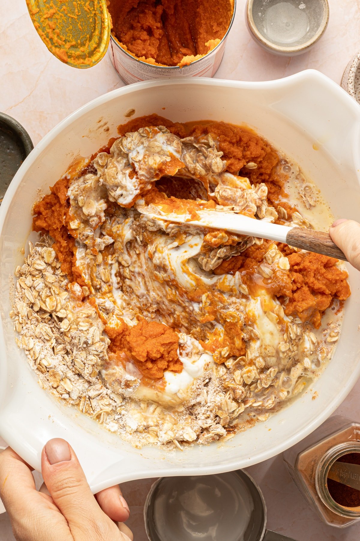 Wet ingredients for protein pumpkin baked oats being mixed with a rubber spatula.