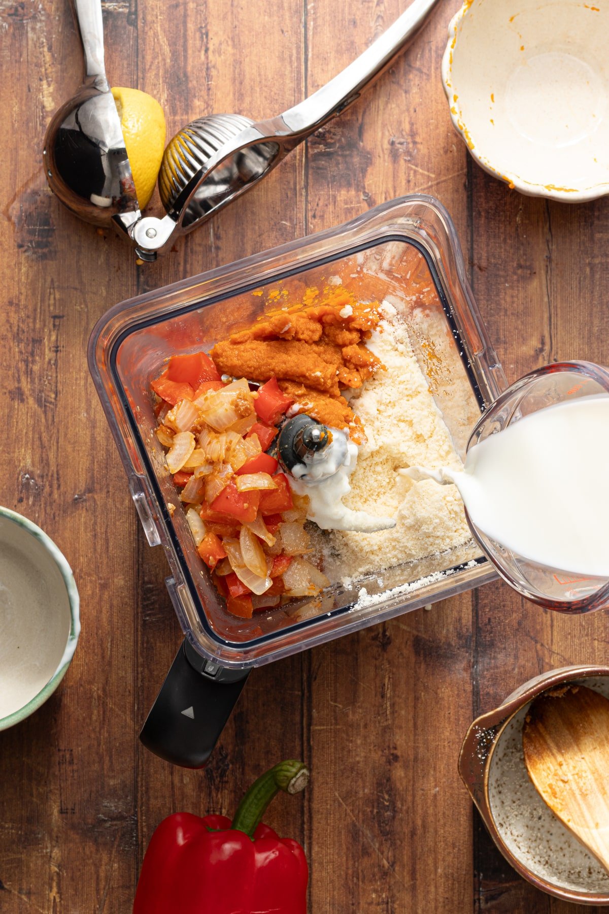 Ingredients for protein pumpkin pasta sauce being added to a blender.