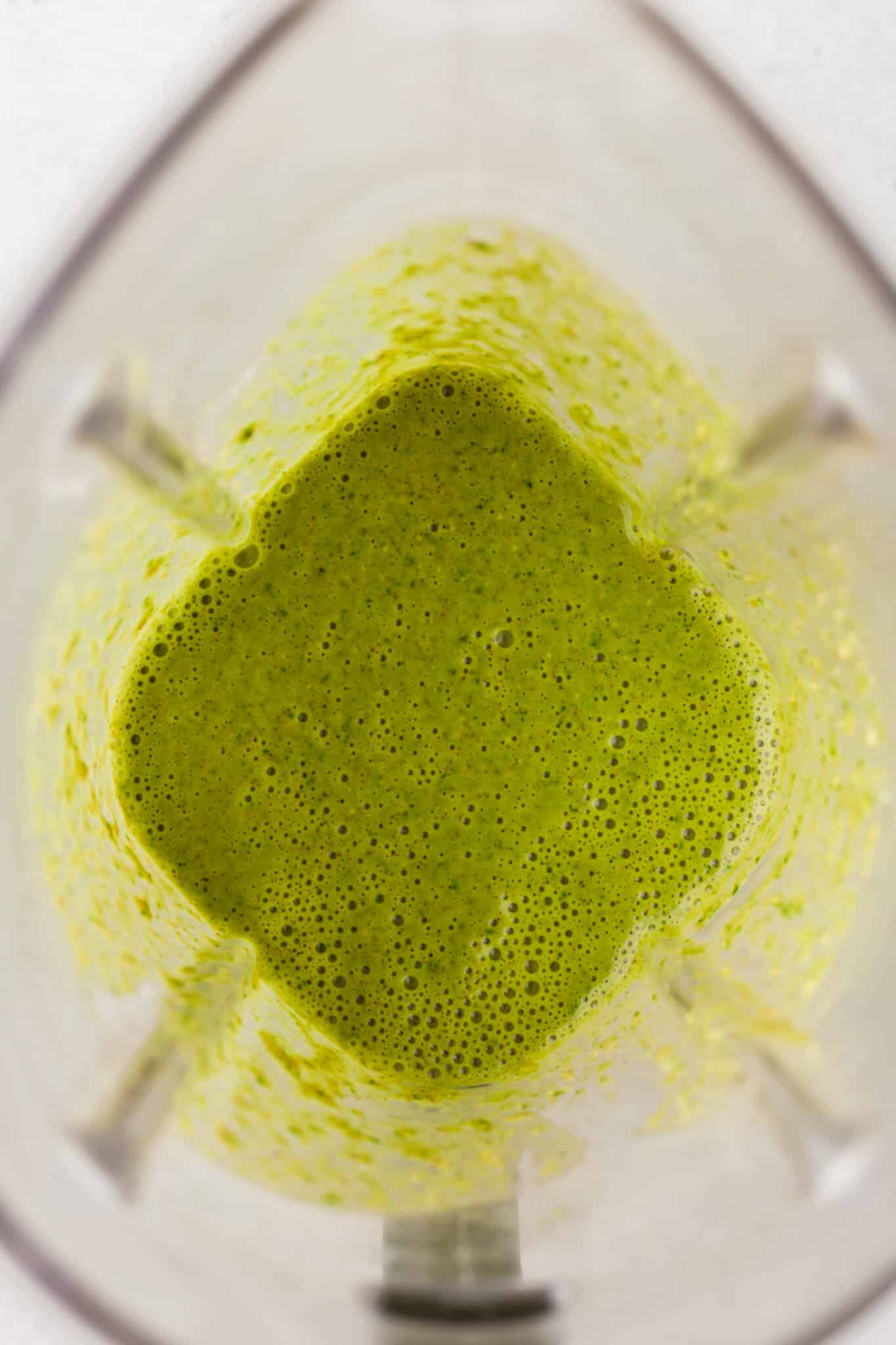 Ingredients for spinach banana muffins blended in a blender.