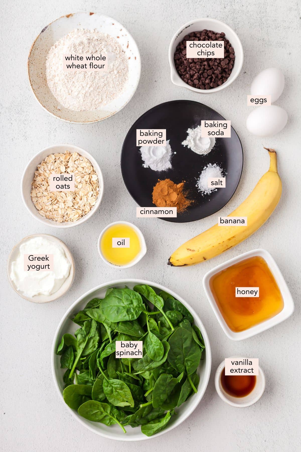 Ingredients for spinach banana muffins on a countertop with labels.