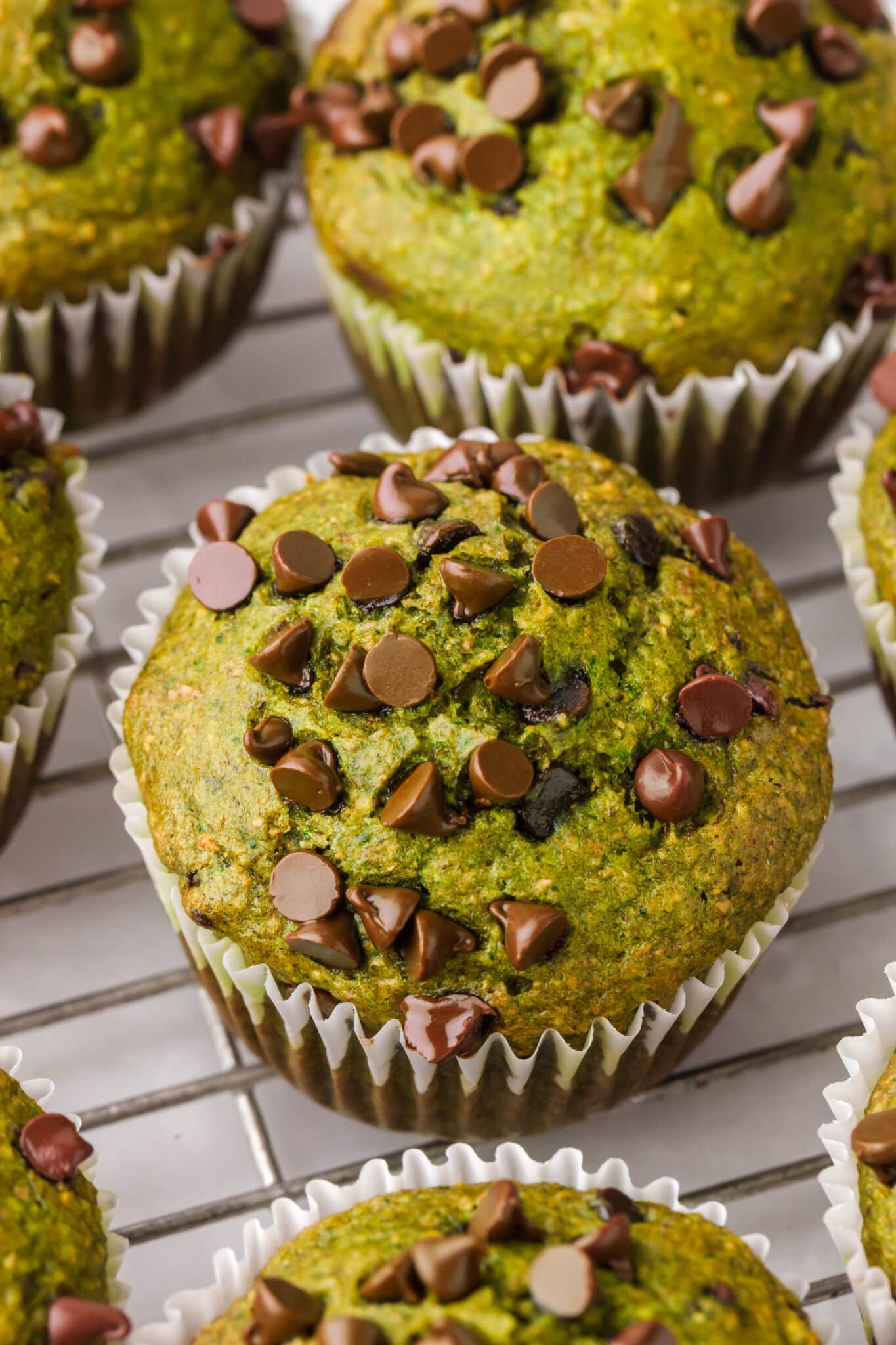 Spinach banana muffins on a cooling rack.