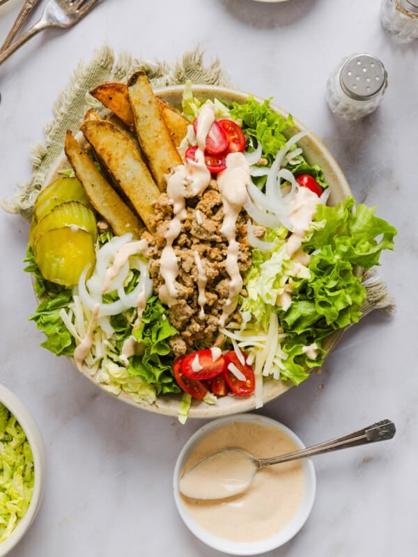 Assembled turkey burger bowl with all the toppings and a drizzle of burger sauce.
