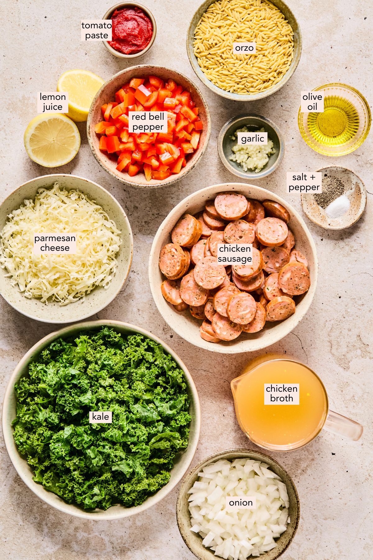 Ingredients for chicken sausage orzo on a countertop with labels. 