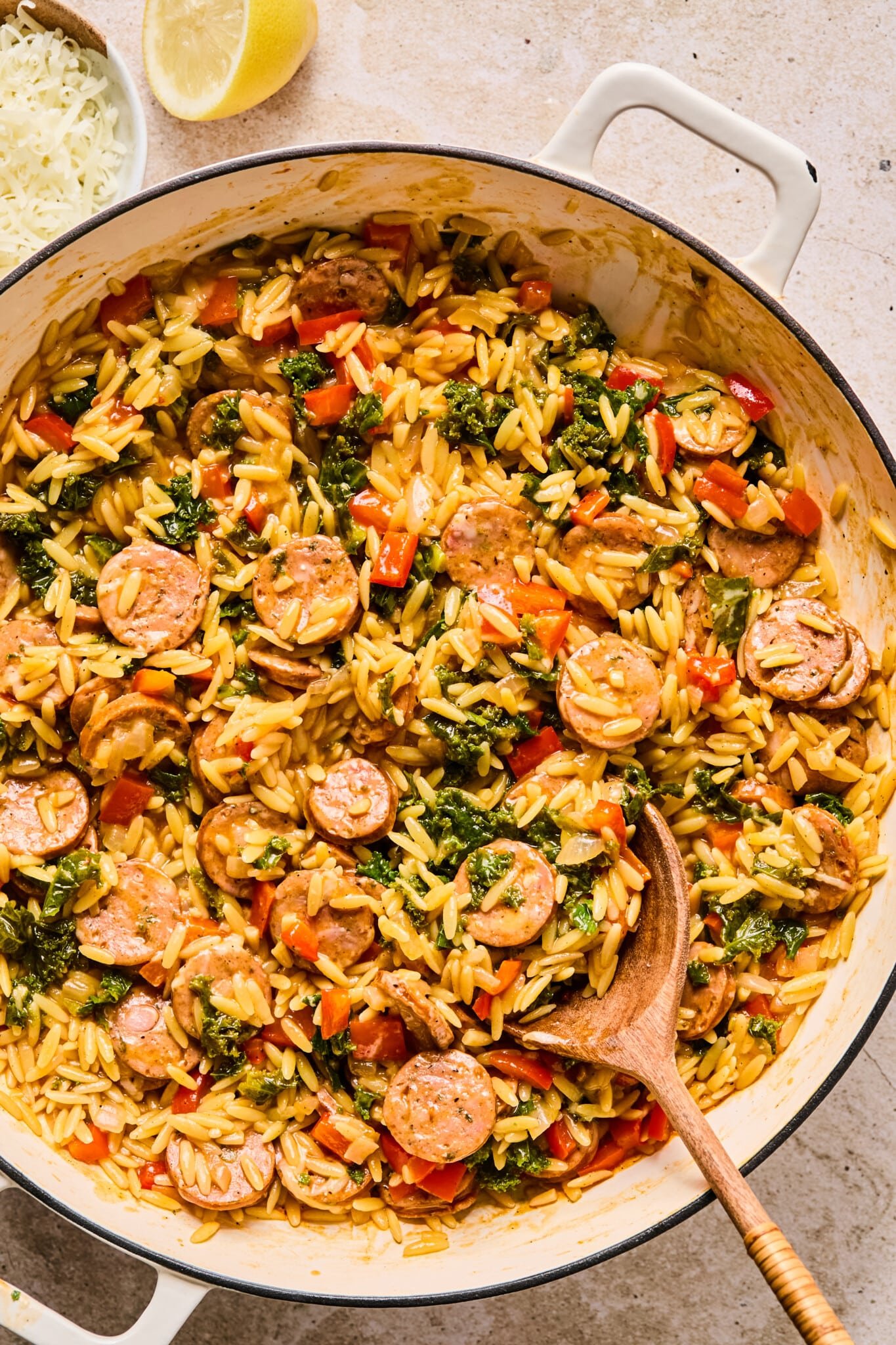 Chicken sausage orzo skillet with kale and bell peppers.