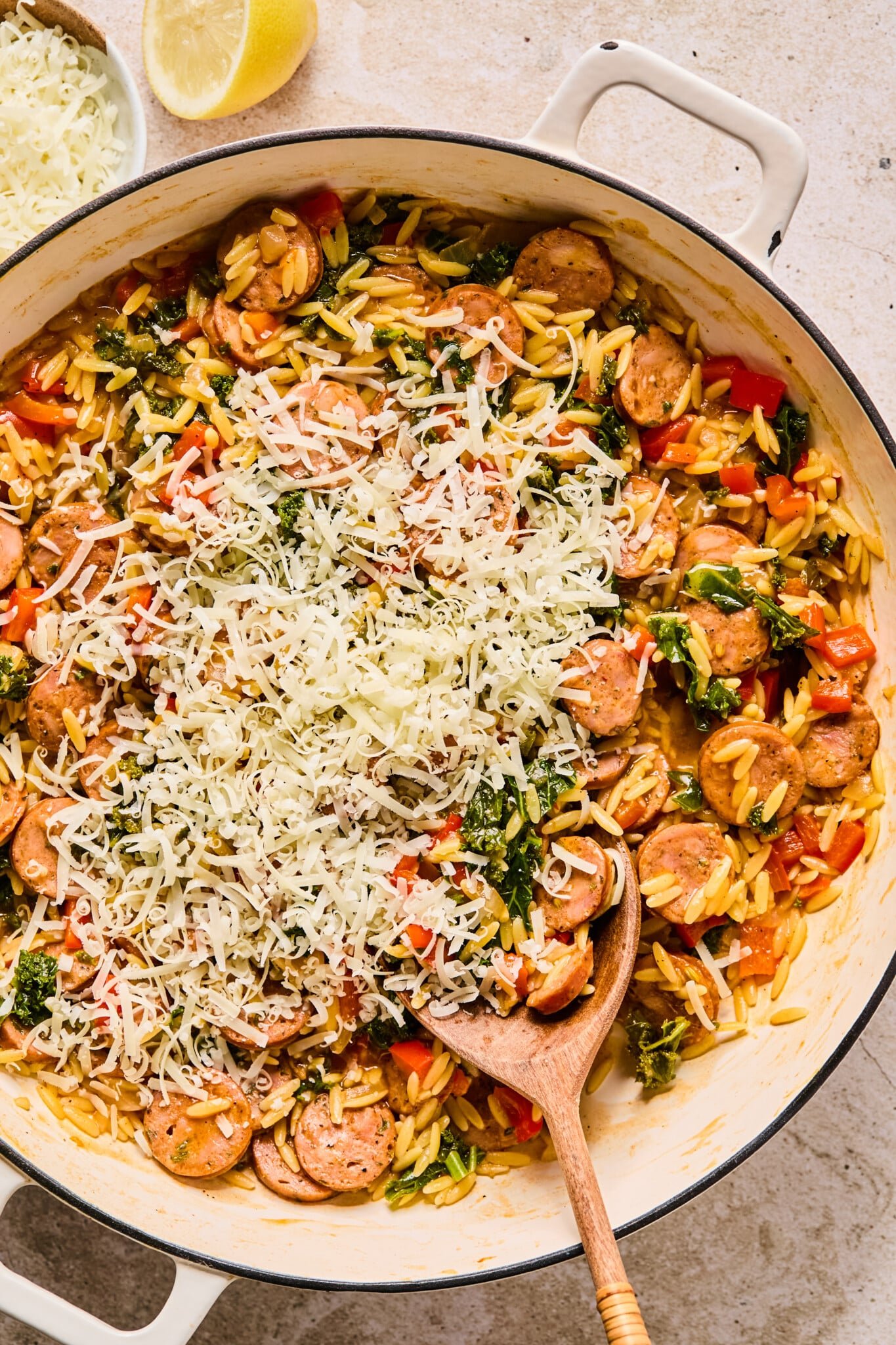 Parmesan cheese added to chicken sausage orzo skillet.