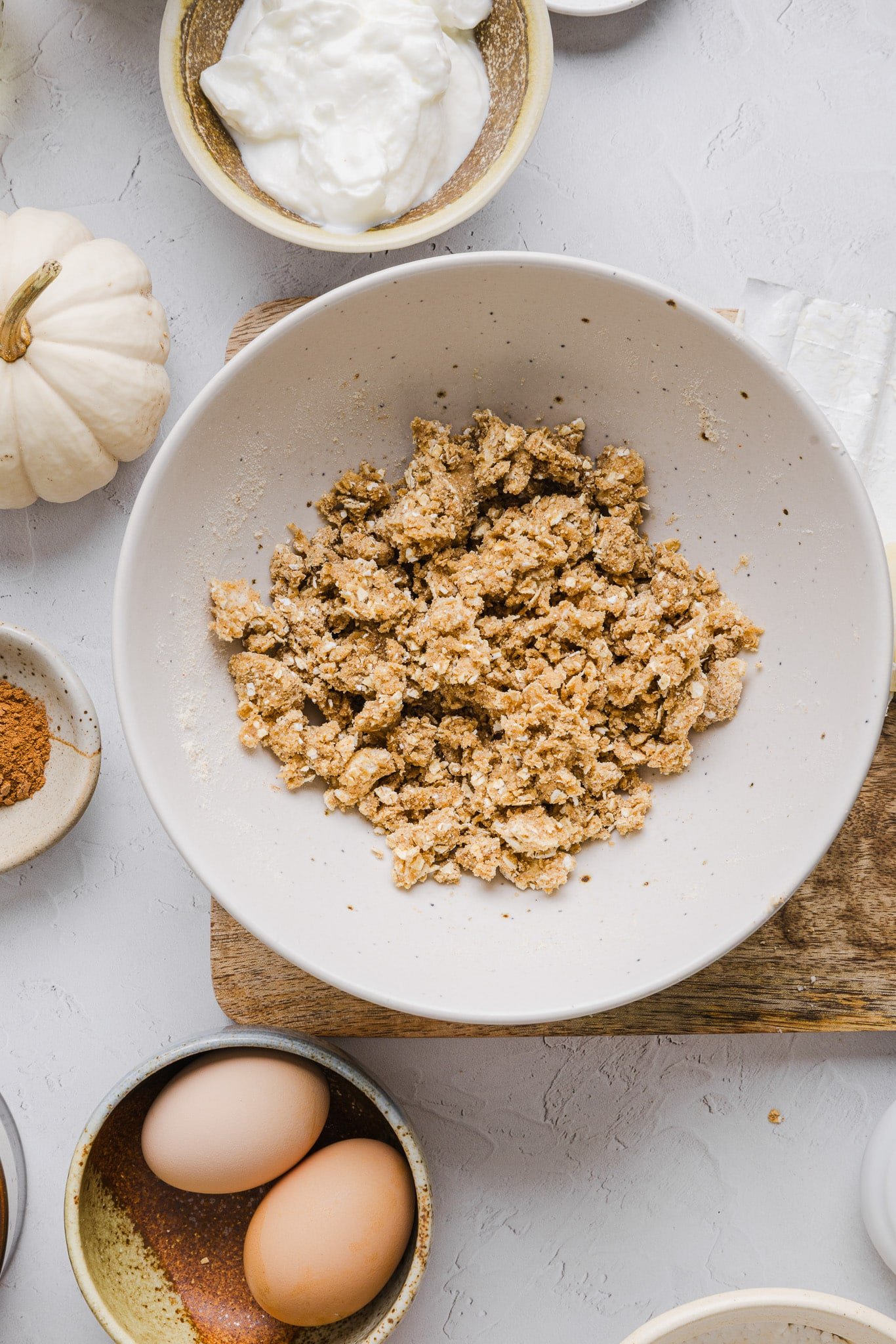 Healthy pumpkin coffee cake stresel topping in a white bowl.