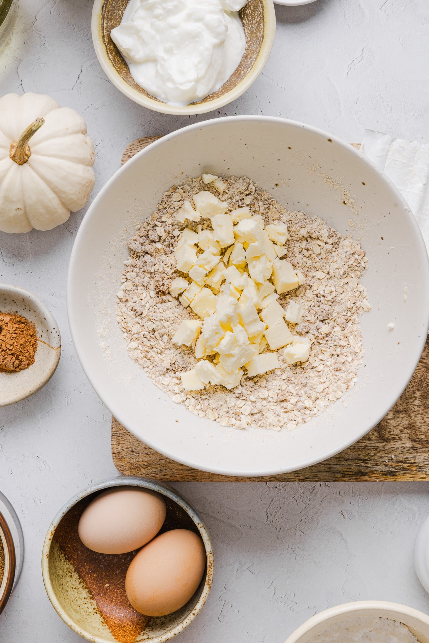 Ingredients for pumpkin coffee cake streusel topping in a white bowl.