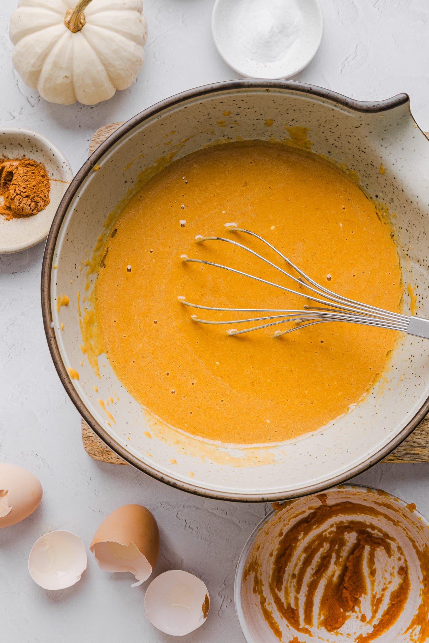 Wet ingredients for healthy pumpkin coffee cake mixed in a bowl.