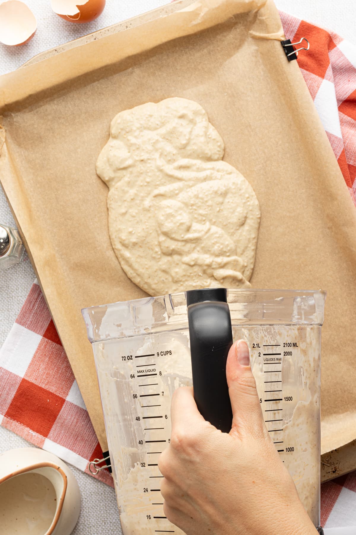 Protein pancake batter being poured onto a sheet pan.
