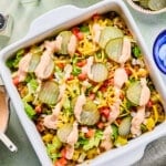 Big mac casserole topped with pickles, diced onion, tomatoes, cheese and a drizzle of sauce.