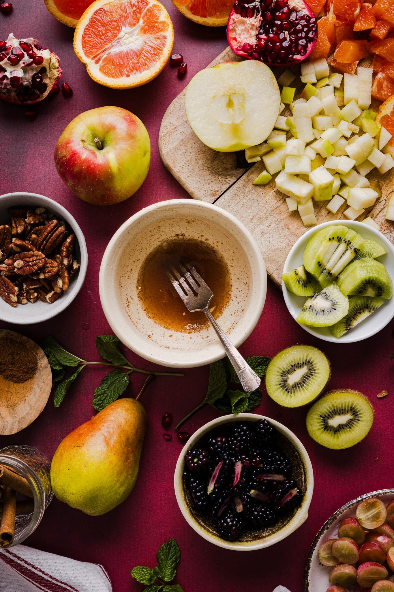 Honey, cinnamon and lemon juice being mixed together in a small bowl for fall fruit salad.