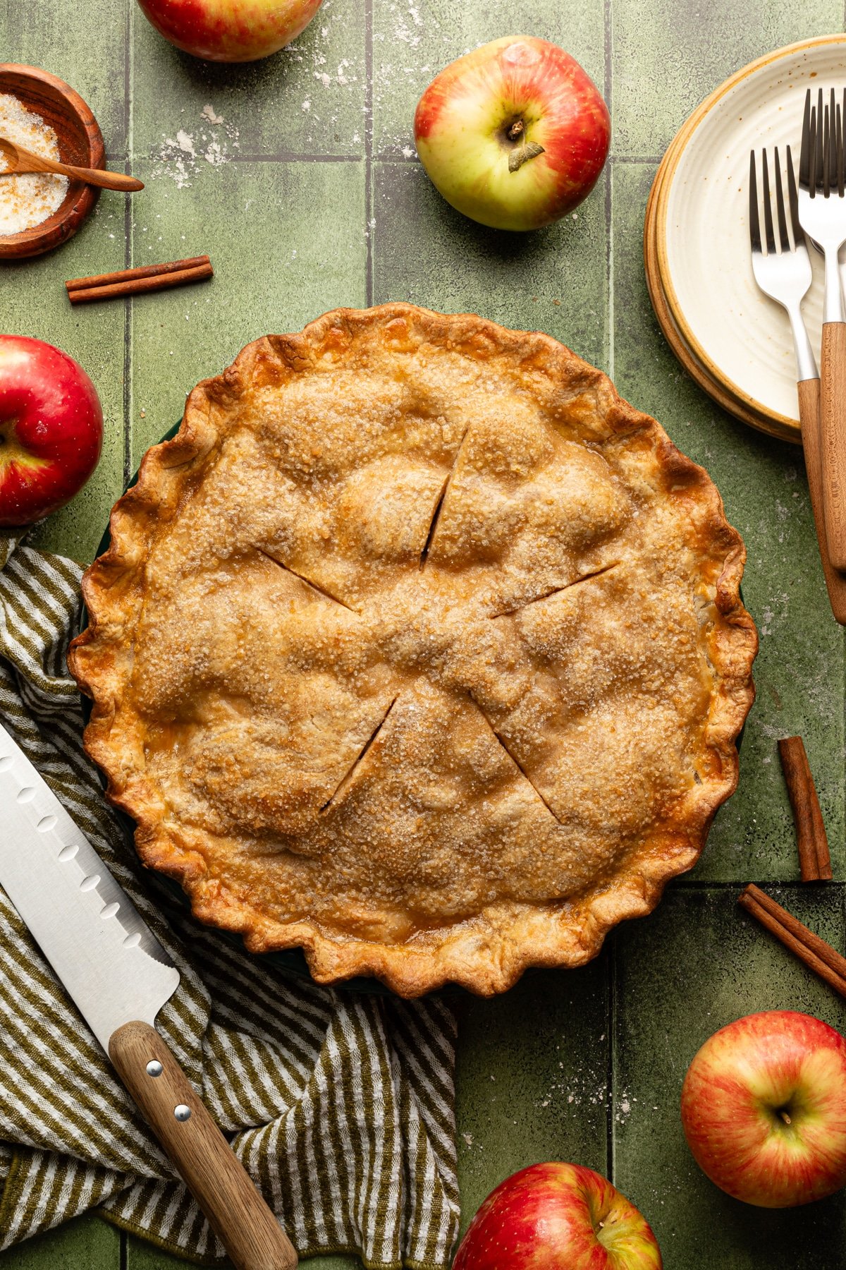 Baked healthy apple pie on a green tablescape.