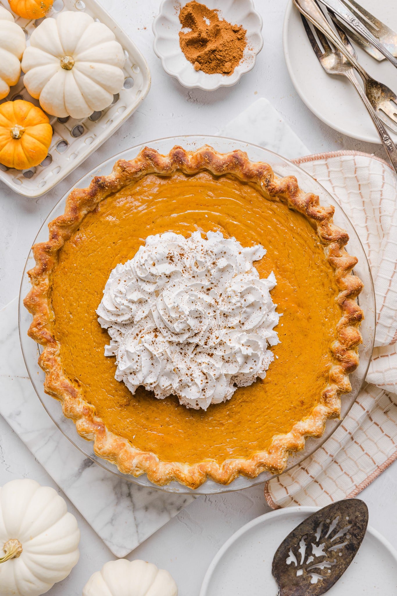 Healthy pumpkin pie topped with whipped cream.