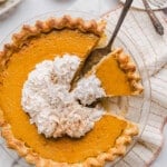 Healthy pumpkin pie topped with whipped cream.