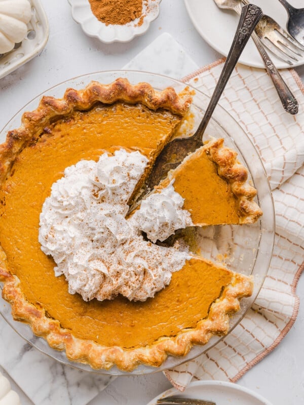 Healthy pumpkin pie topped with whipped cream.