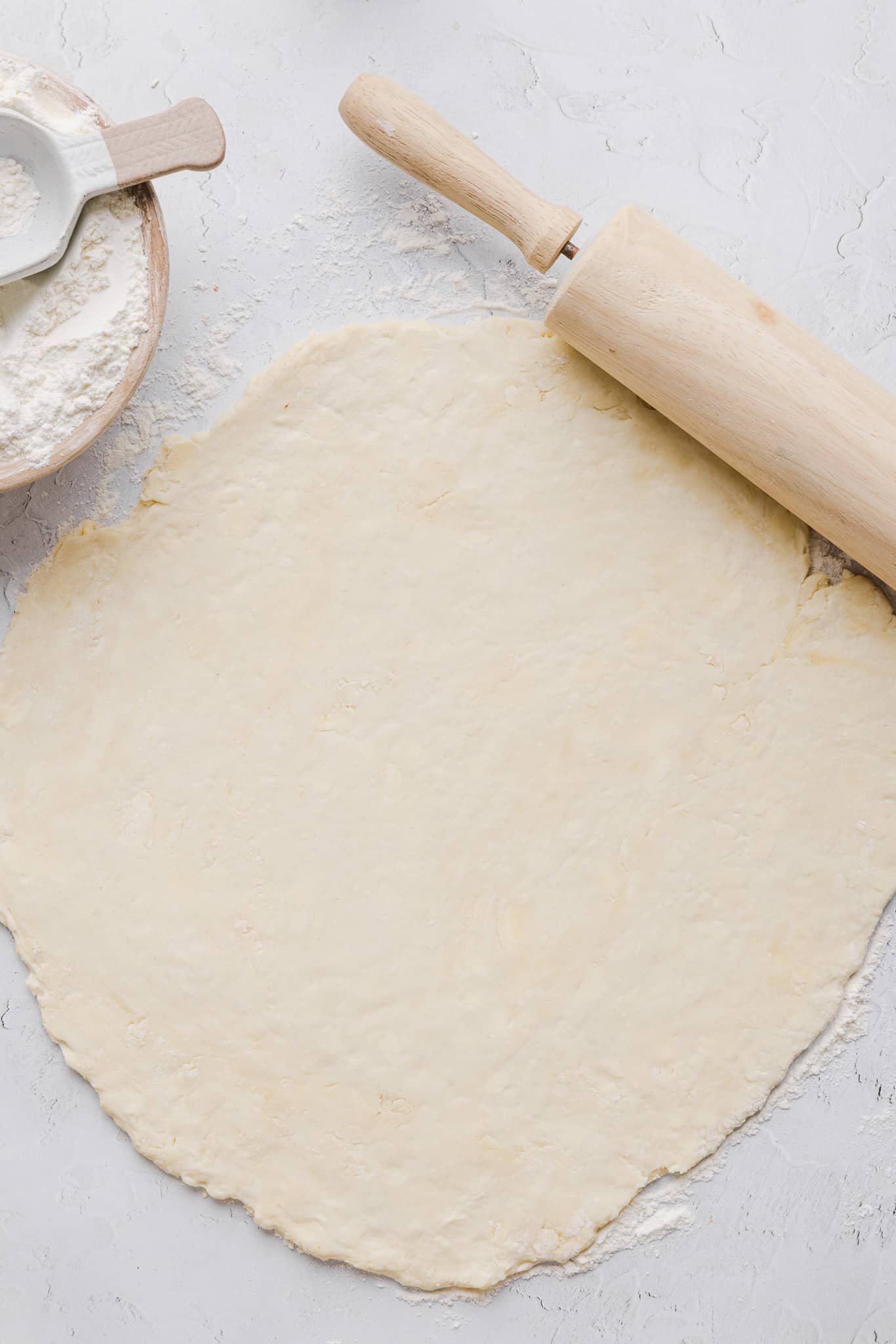 Healthy pumpkin pie crust rolled out on a countertop.