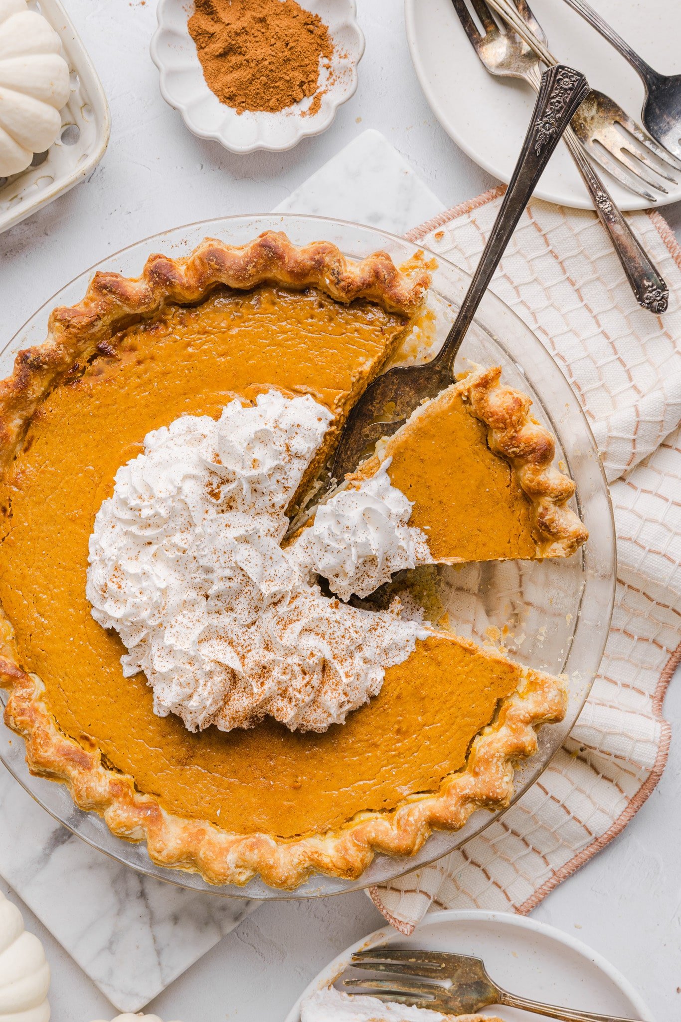 Healthy pumpkin pie topped with whipped cream.