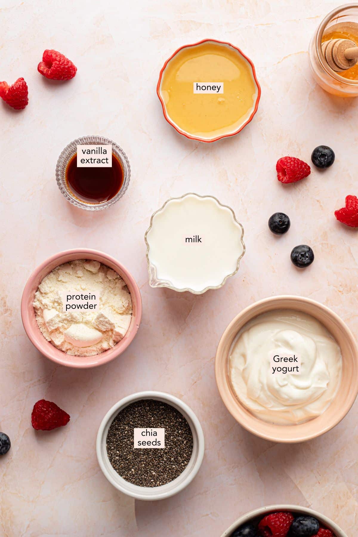 Protein chia pudding ingredients on a countertop with labels.