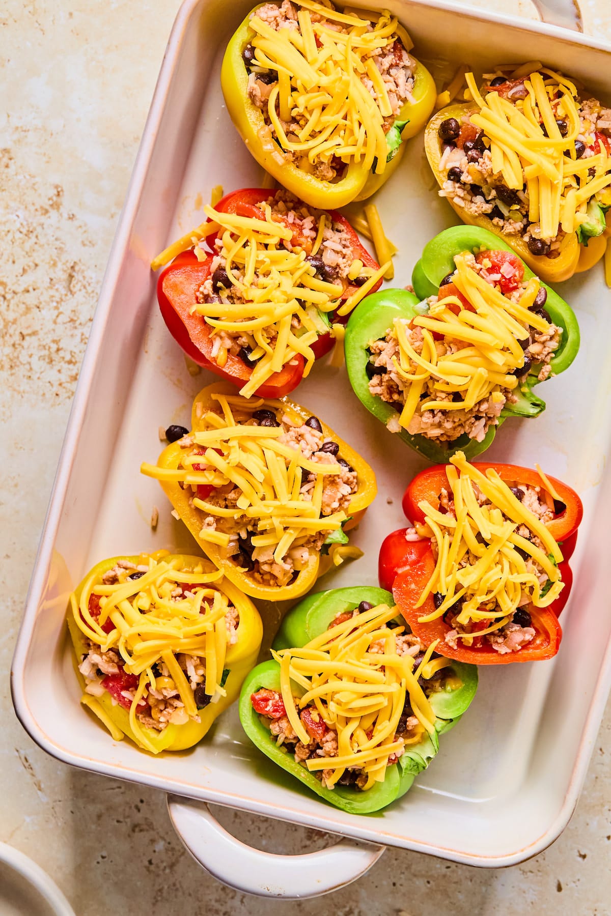 Bell pepper halves stuffed with a meat and veggie filling and topped with cheese.