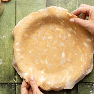 Whole wheat pie crust in a pie plate.