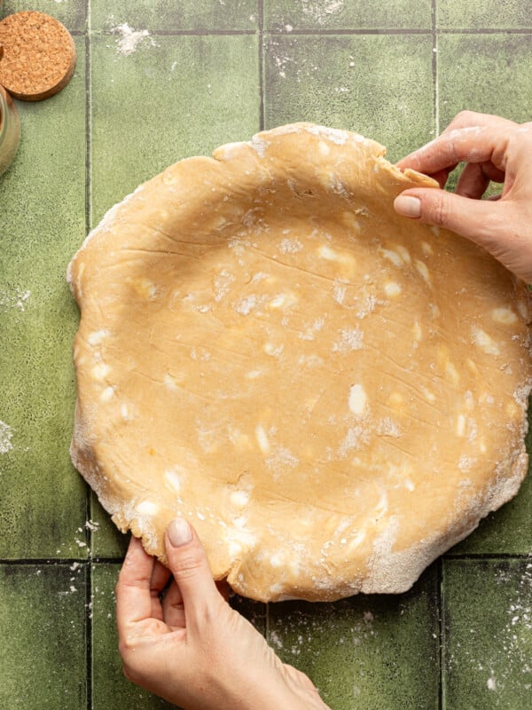 Whole wheat pie crust in a pie plate.