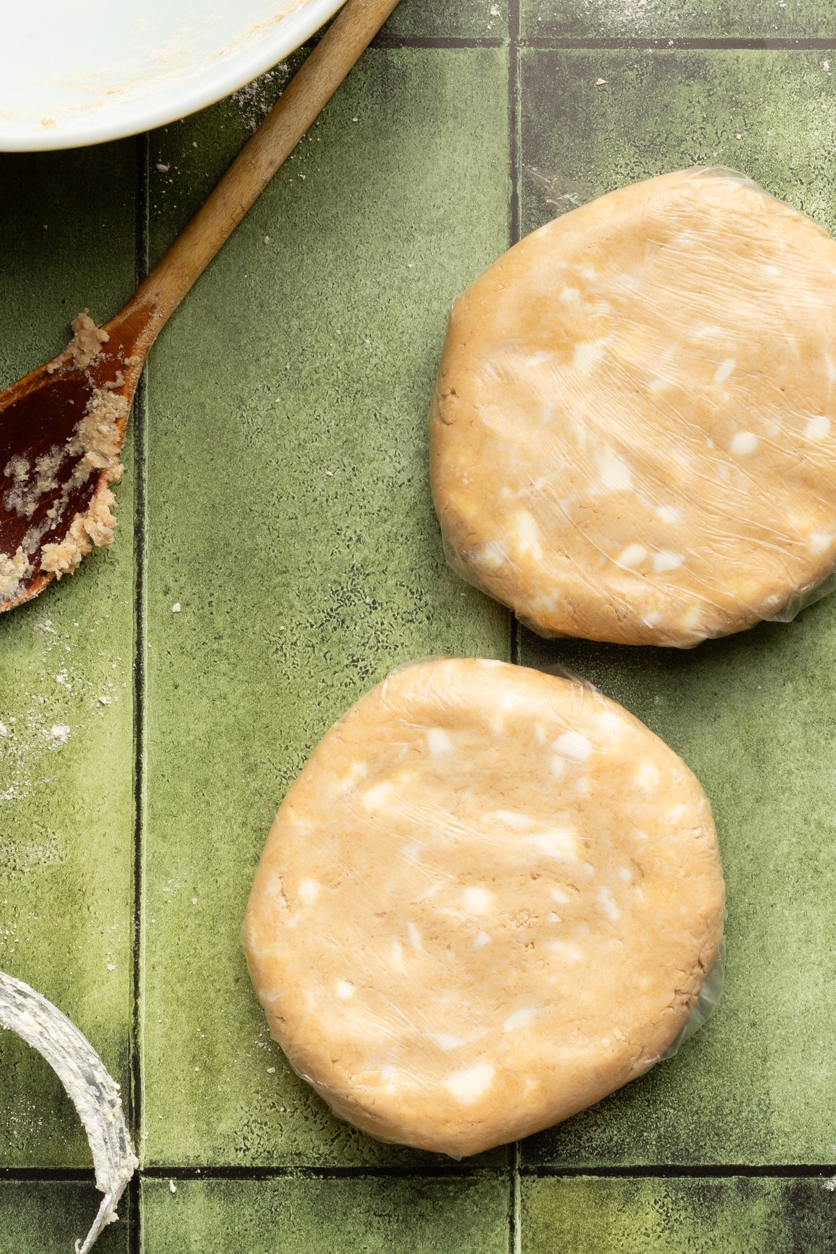 Two whole wheat pie crust doughs shaped into disks.