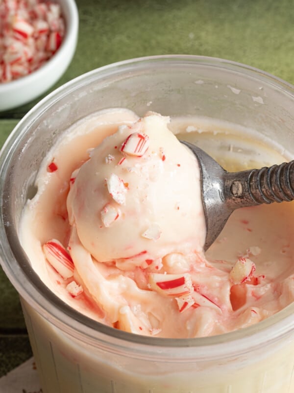 Ninja Creami peppermint ice cream being scooped out of the clear pint container.