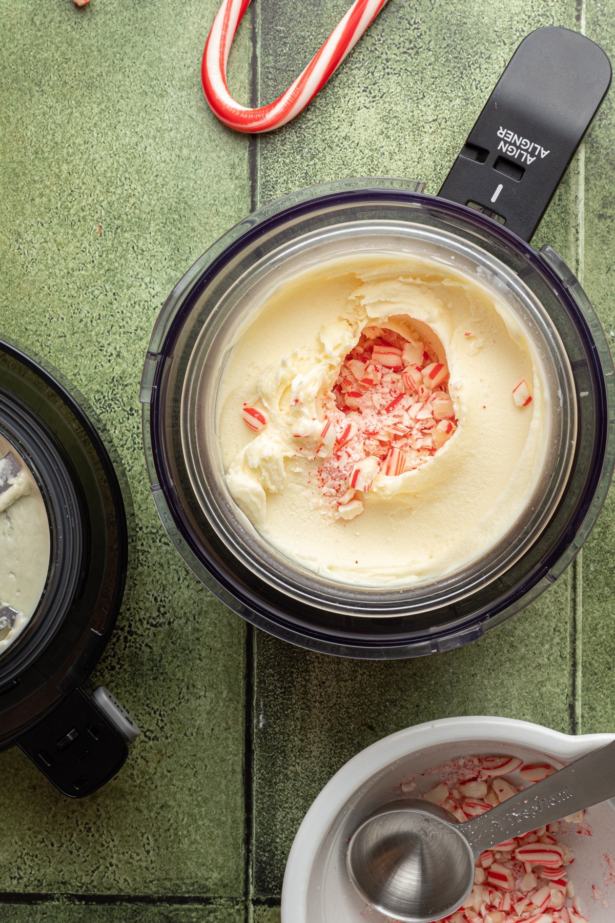 Ninja Creami ice cream base after initial spins with a hole in the center filled with crushed peppermints.