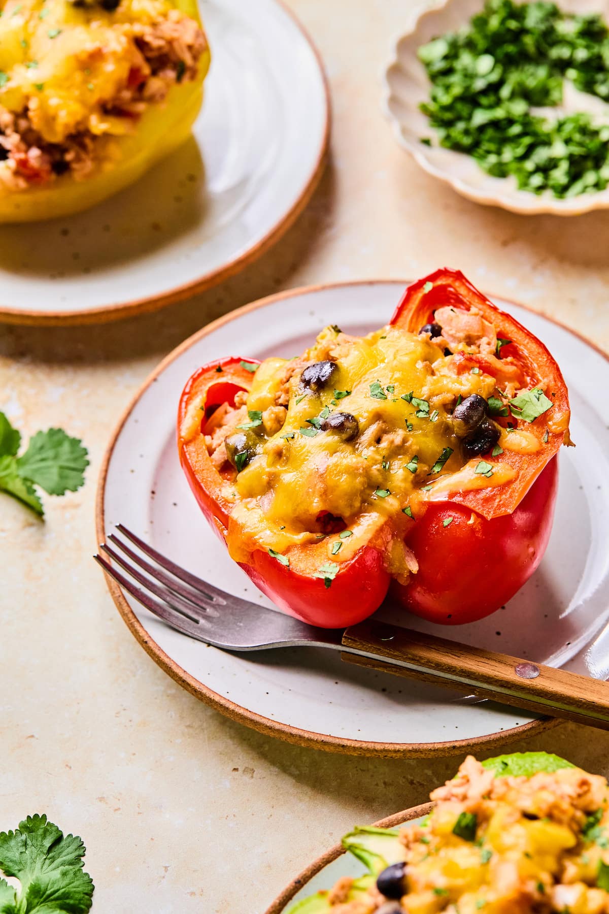 A high protein stuffed bell pepper on a plate with a fork.