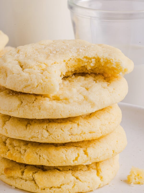 Whole wheat sugar cookies stacked with a bite taken out of the top cookie.