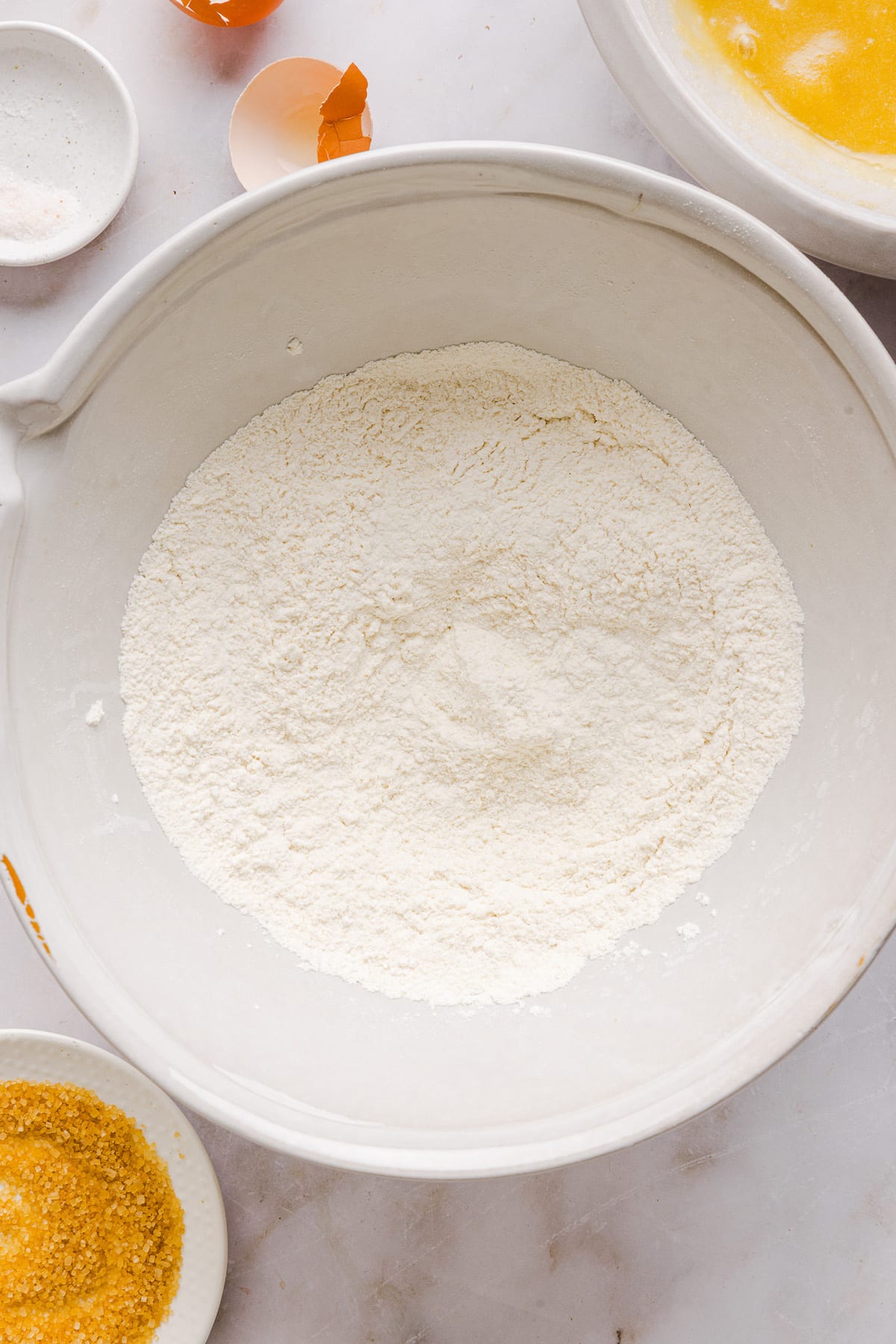 Flour, salt and baking soda mixed in a large bowl for whole wheat sugar cookies.