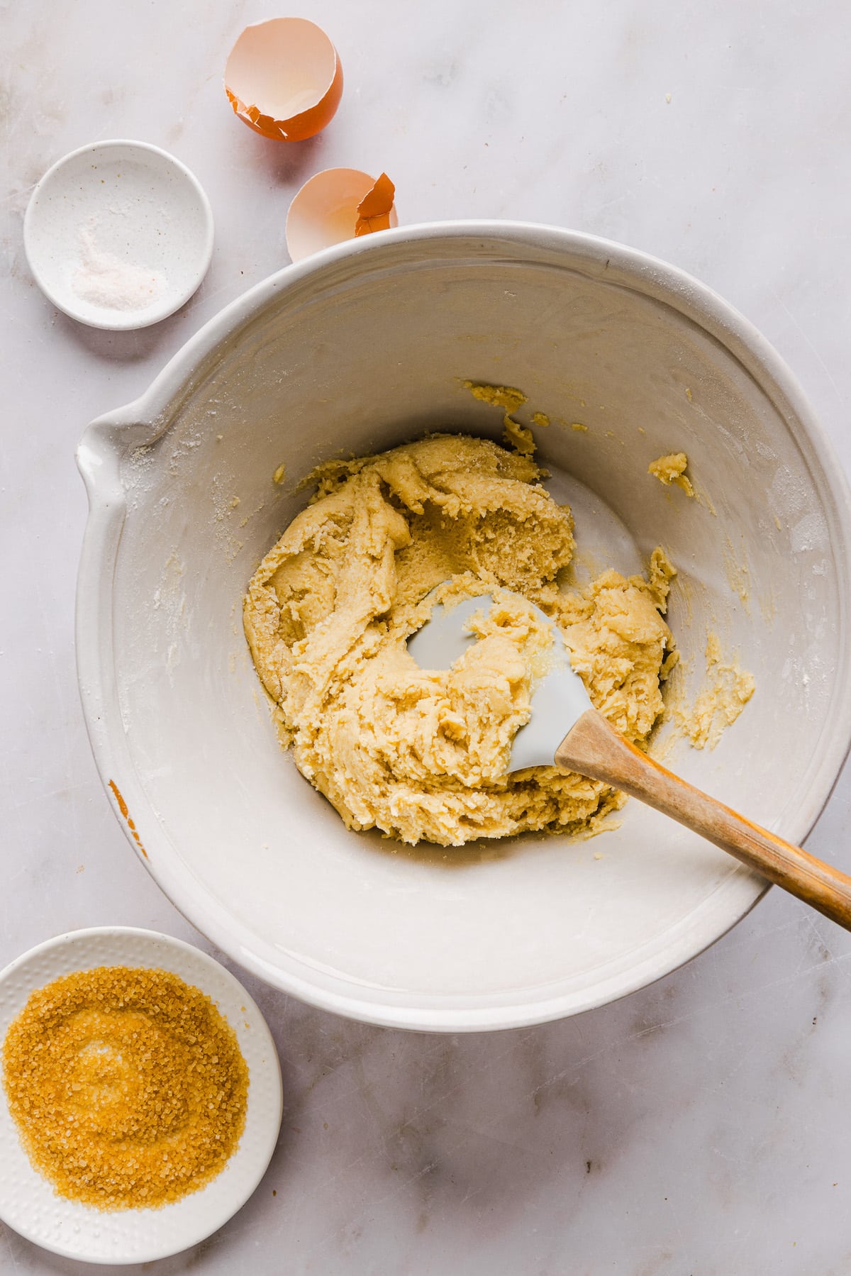 Whole wheat sugar cookie dough in a large mixing bowl with a rubber spatula.
