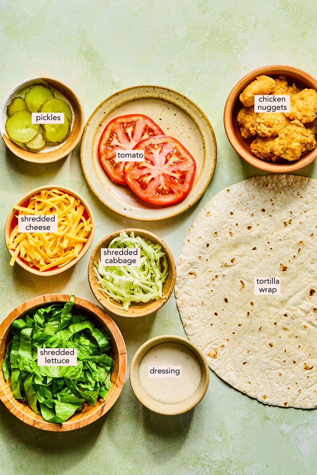 Ingredients for an easy chicken nugget wrap on a countertop with labels.