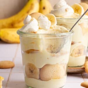 High protein banana pudding layered in a jar with whipped cream.