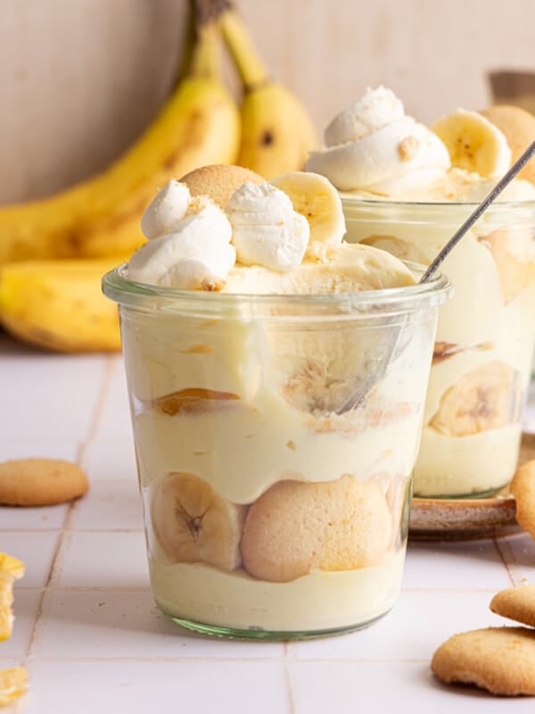 High protein banana pudding layered in a jar with whipped cream.