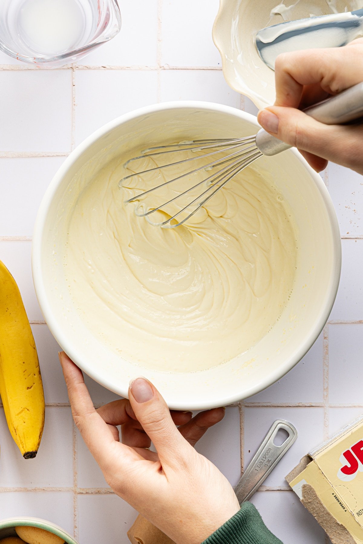 High protein banana pudding being whisked in a bowl.