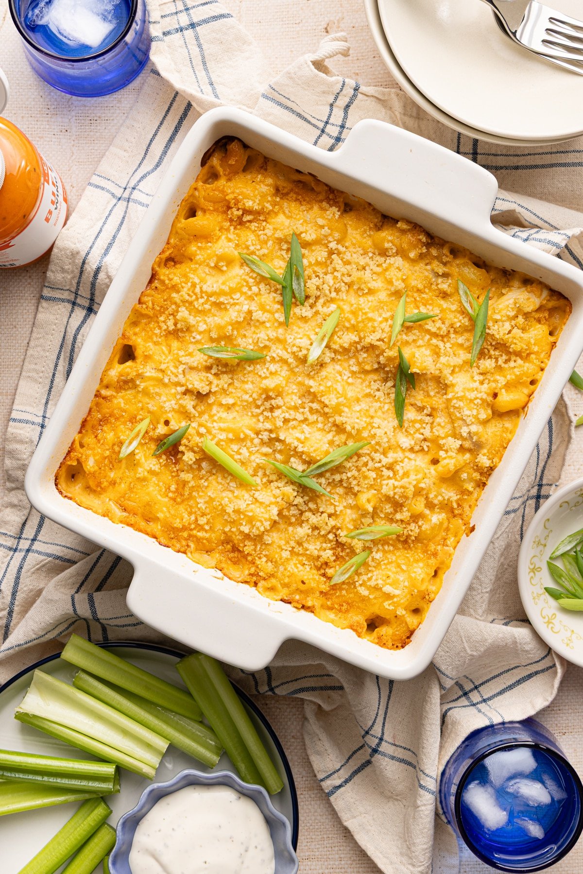 Baked high protein buffalo chicken mac and cheese garnished with sliced scallions.