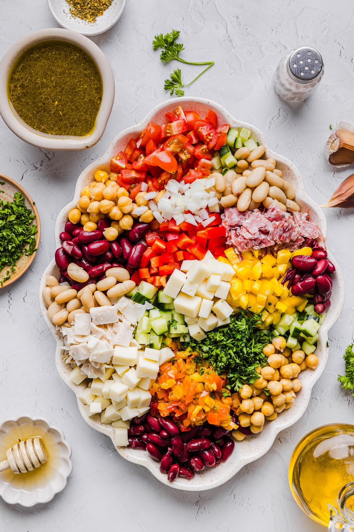 Italian grinder dense bean salad ingredients on a platter.
