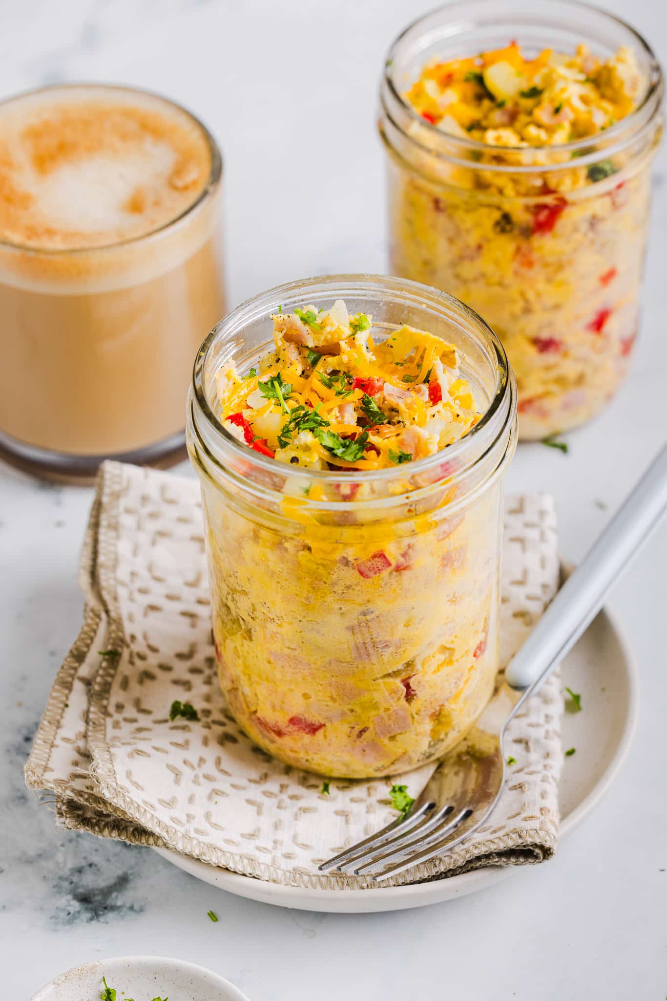 Just Crack an Egg copycat in a mason jar in front of a cup of coffee.