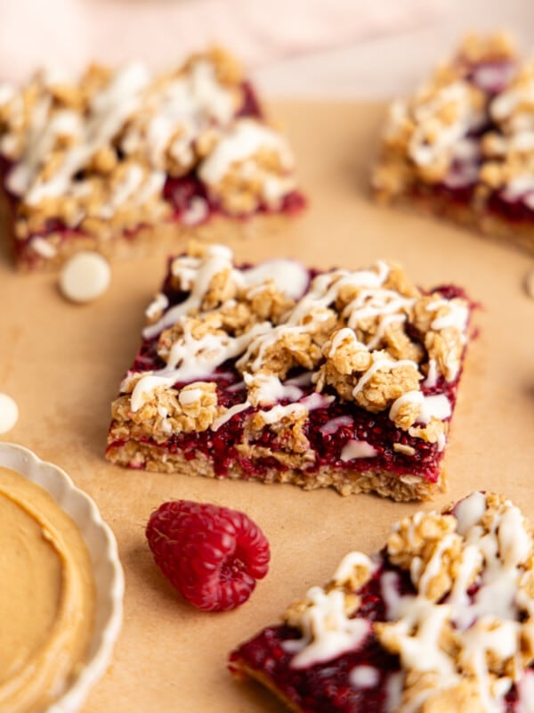 No bake PB and J oat bars sliced on parchment paper.