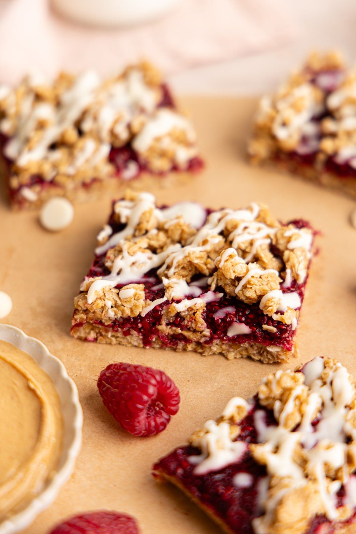 No bake PB and J oat bars sliced on parchment paper.