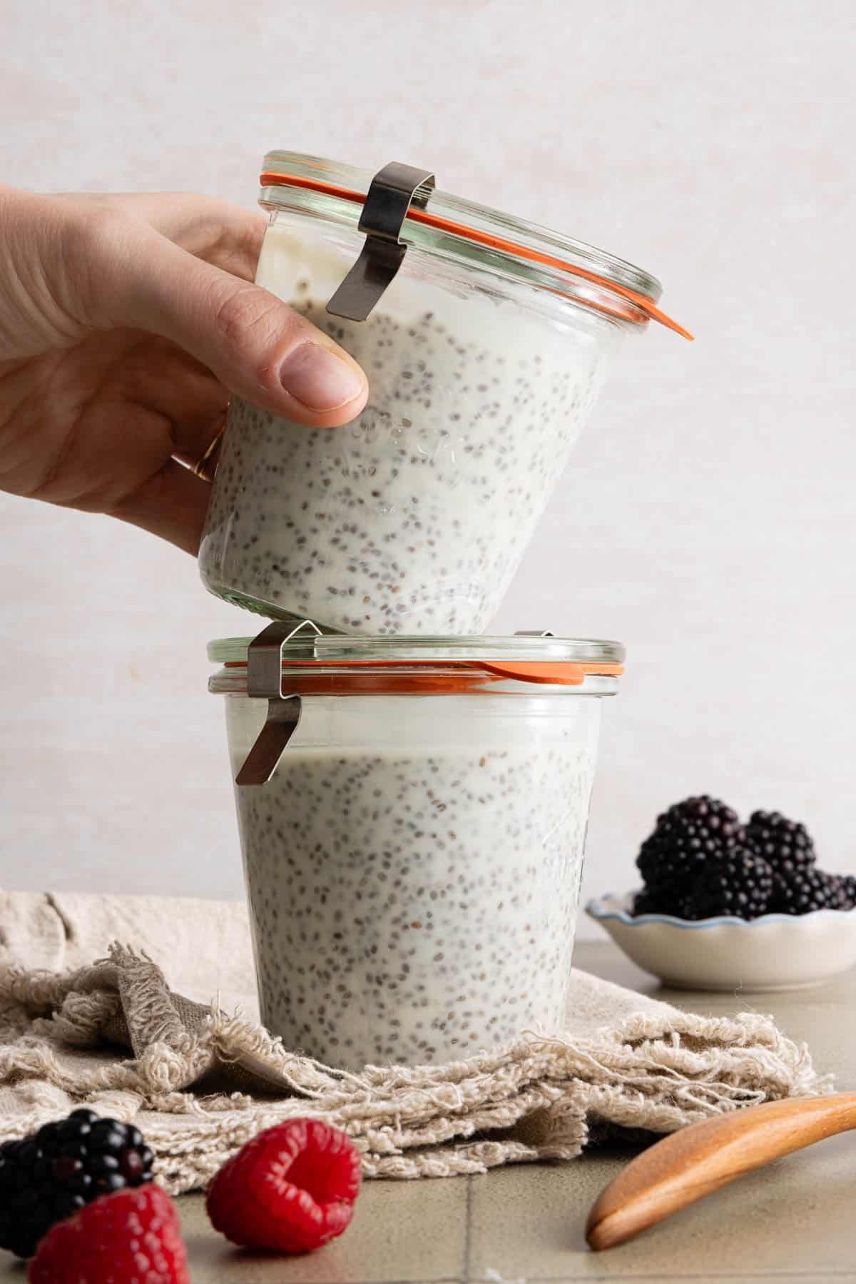 Two jars filled with kefir chia pudding stacked on top of each other.