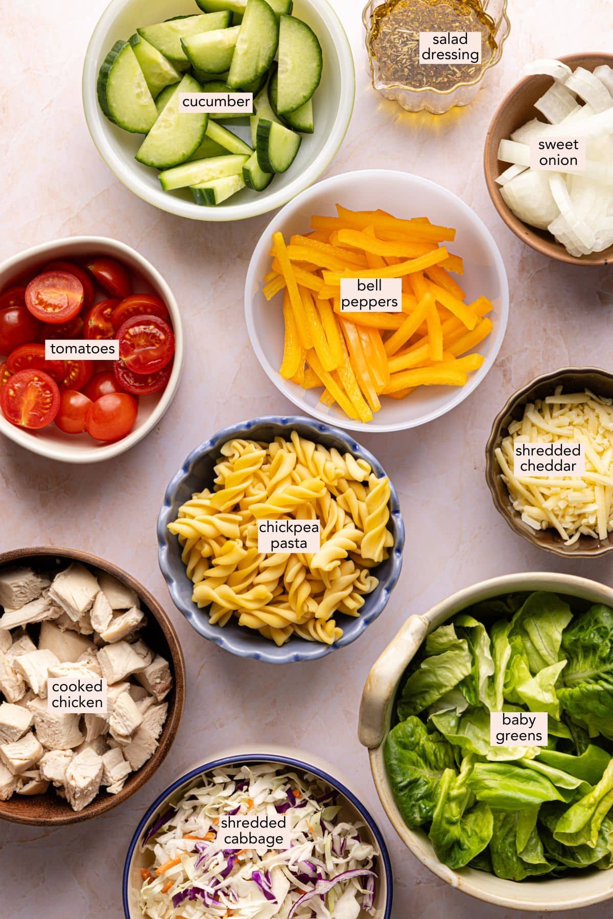 Lunch salad ingredients on a countertop with labels.