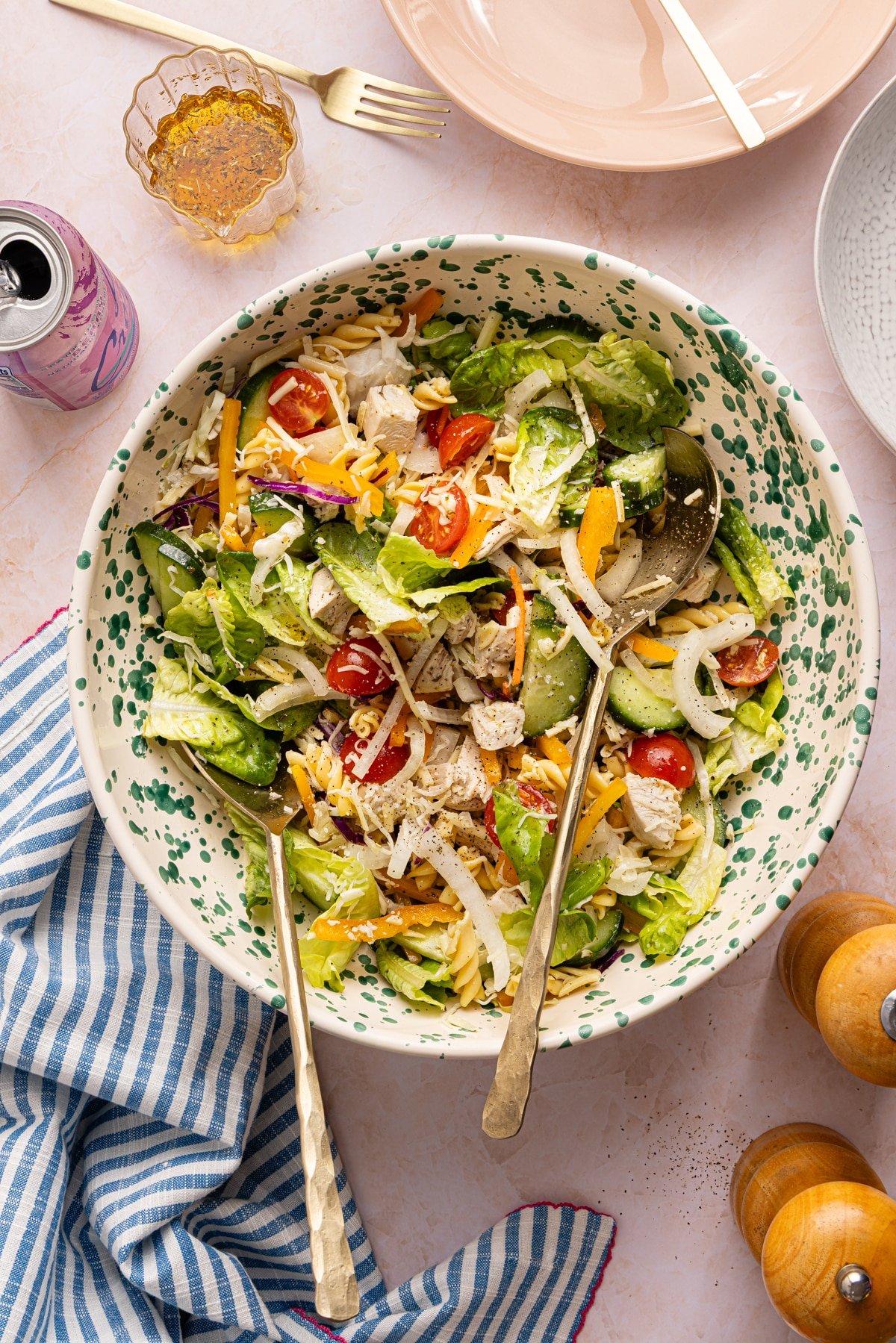 A lunch salad with chicken, pasta, veggies and dressing tossed in a bowl.