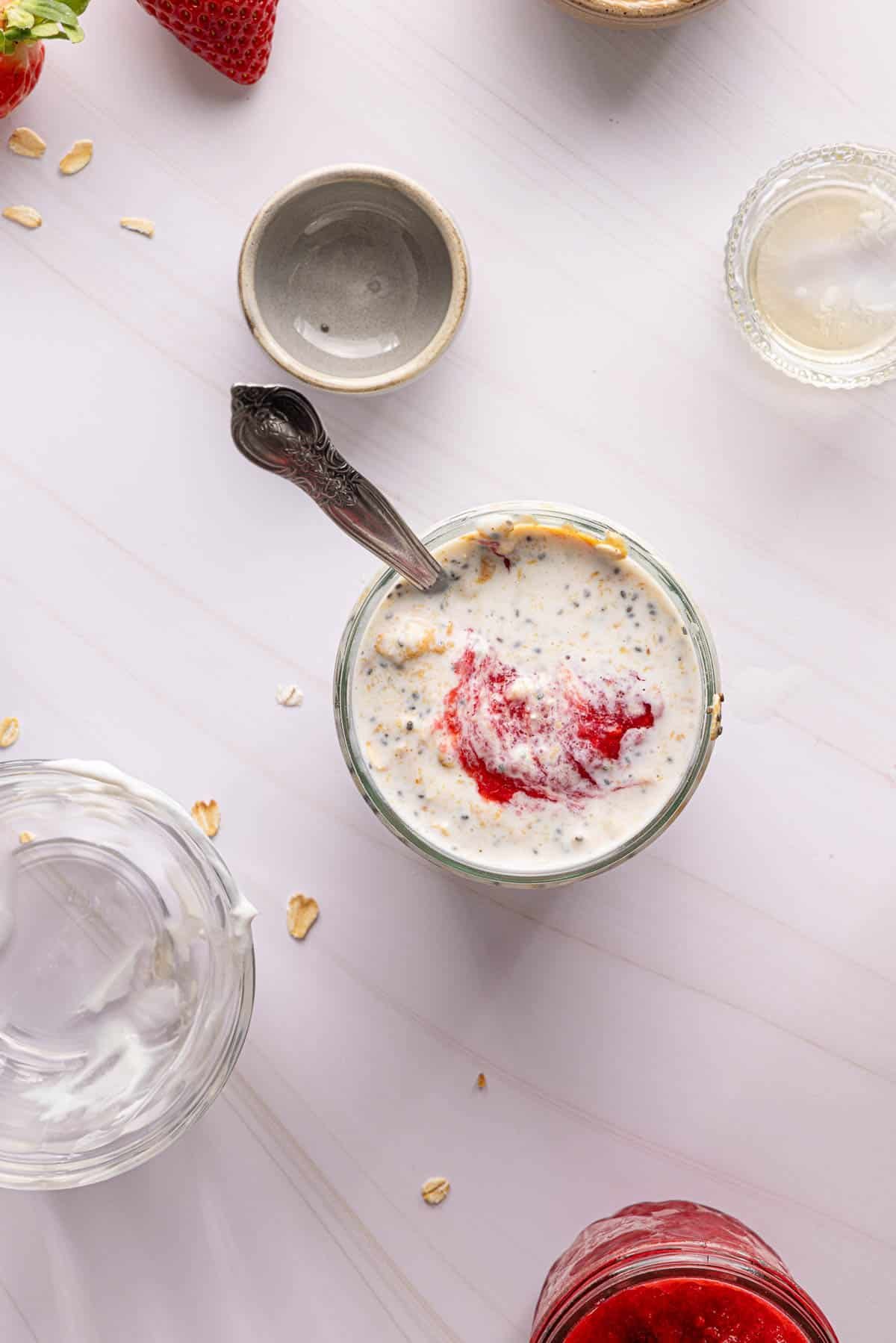 The stirred pb and j overnight oats in a jar before chilling.