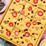 The baked sheet pan pancakes in the sheet pan cut into 12 slices.