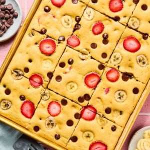 The baked sheet pan pancakes in the sheet pan cut into 12 slices.