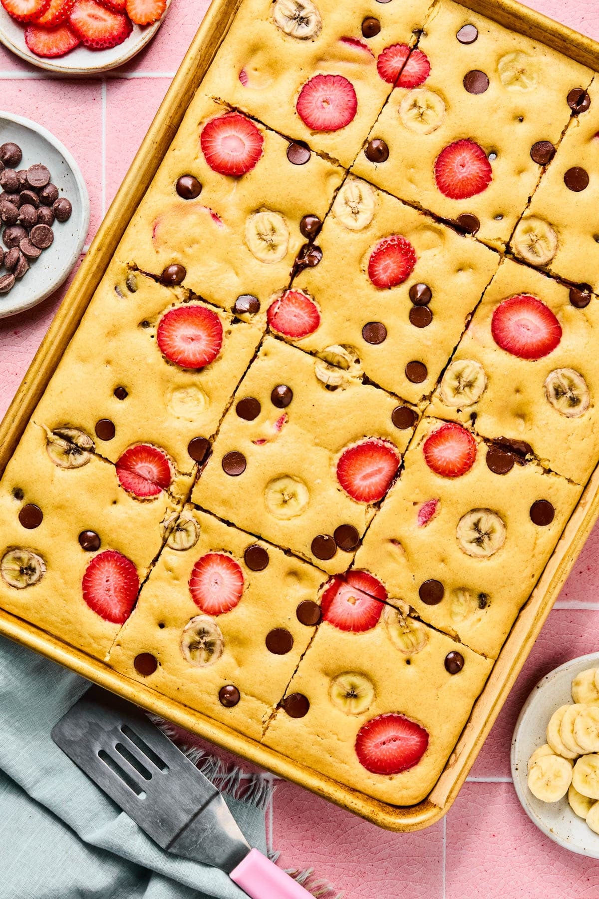 The baked sheet pan pancakes in the sheet pan cut into 12 slices.