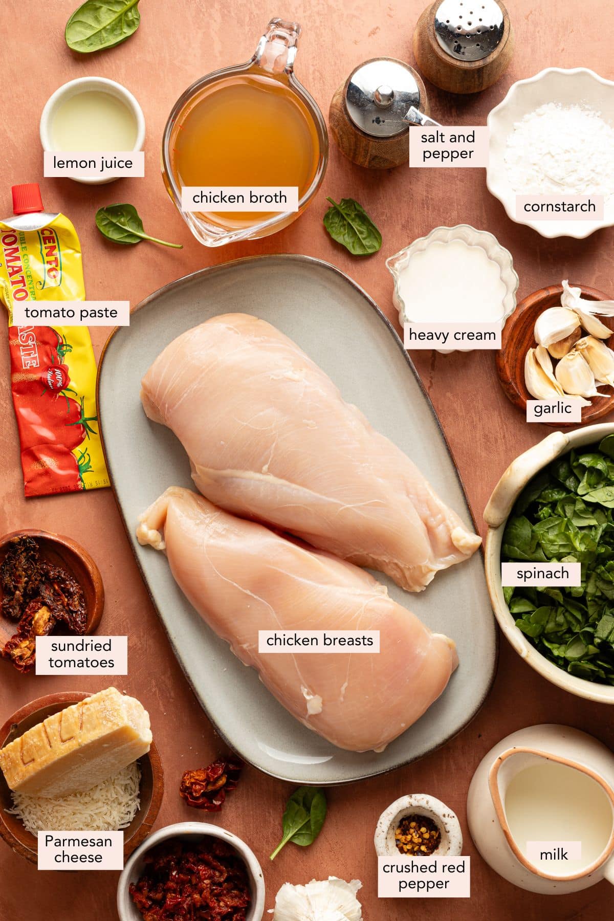 All of the ingredients for slow cooker marry me chicken in bowls or plates on a countertop.