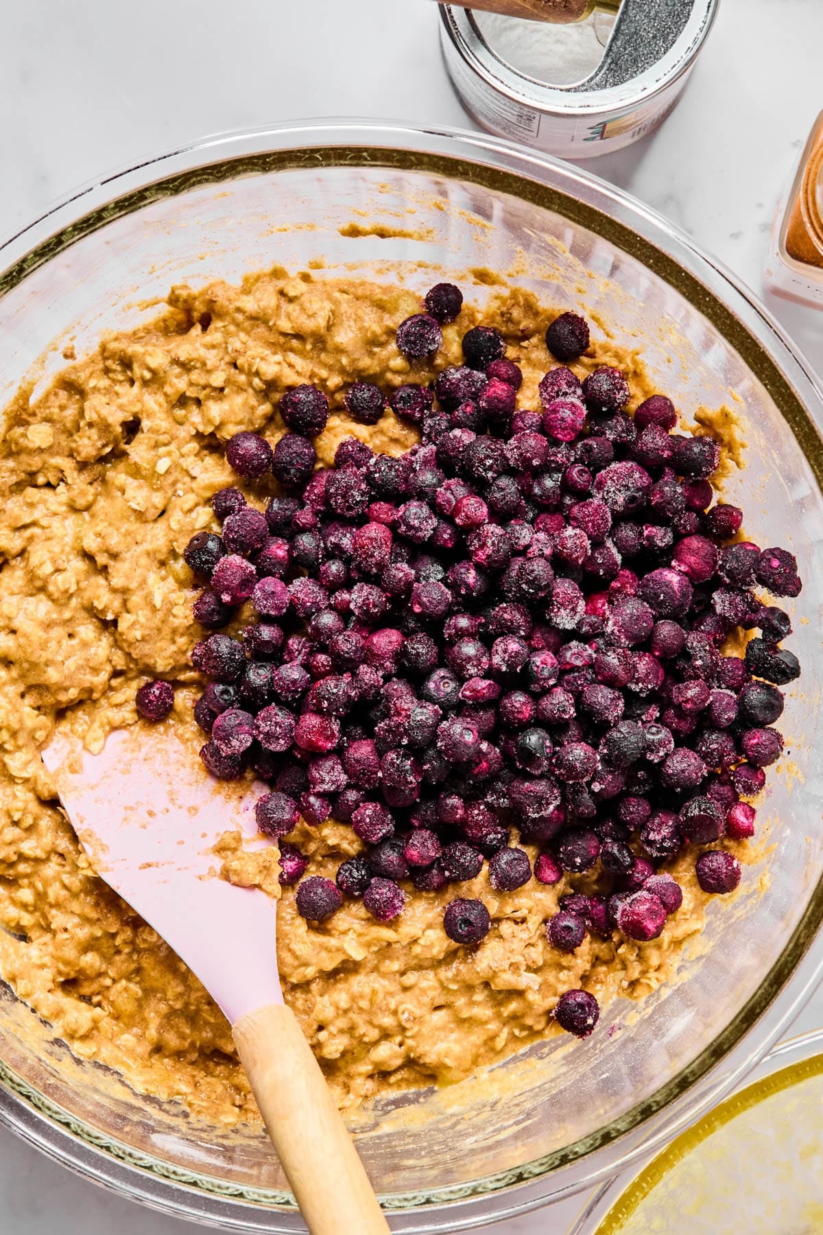 The wild blueberries in the bowl with the muffin batter before folding in.